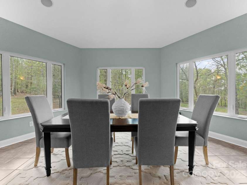 10200 Amsterdam Drive, Mount Pleasant, NC 28124.  MLS# CAR4213612, YatesRealty ID 31037. Panoramic views in the solarium style dining room. Overlooking the scenery- enjoy your first cup of coffee or unwind with a glass of wine here