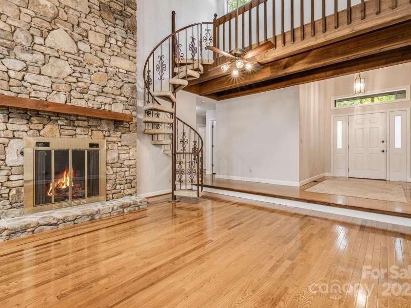 24 Penne Way, Flat Rock, NC 28731.  MLS# CAR4269112, YatesRealty ID 31045. Spiral staircase leads to a loft space off the main living area