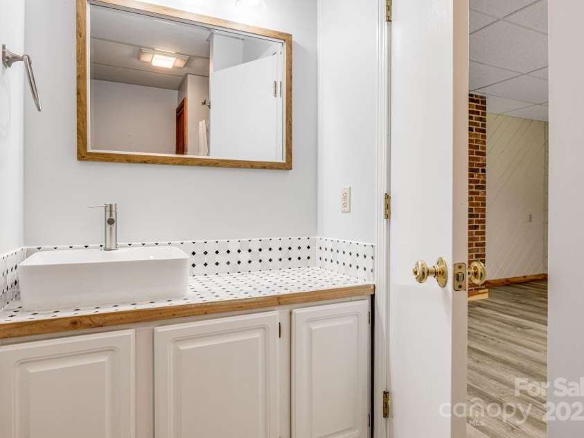 24 Penne Way, Flat Rock, NC 28731.  MLS# CAR4269112, YatesRealty ID 31045. The large bonus room features plenty of storage space and an attached full bathroom