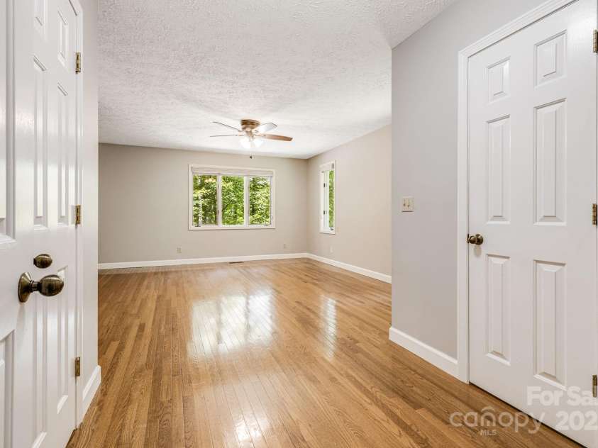 24 Penne Way, Flat Rock, NC 28731.  MLS# CAR4269112, YatesRealty ID 31045. The primary bedroom features hardwood floors, his and her closets, and an ensuite bathroom