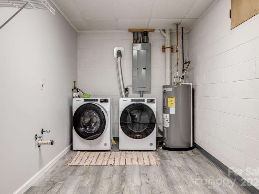 24 Penne Way, Flat Rock, NC 28731.  MLS# CAR4269112, YatesRealty ID 31045. The spacious utility room provides ample space to do laundry and store your cleaning supplies