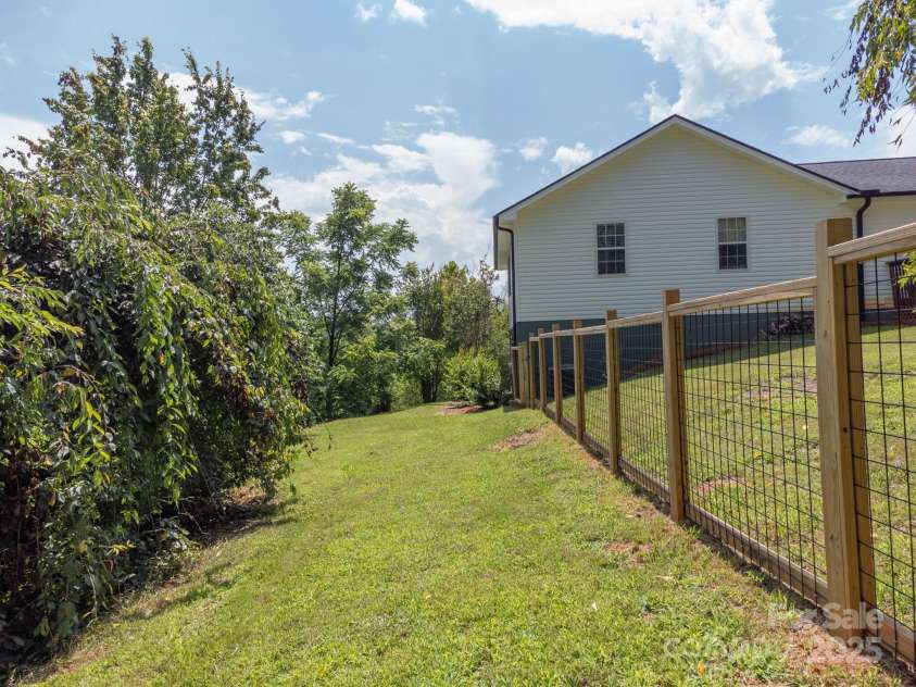 142 Ridge Brook Drive, Weaverville, NC 28787.  MLS# CAR4332710, YatesRealty ID 31054. Back Going Toward Garage Entrance
