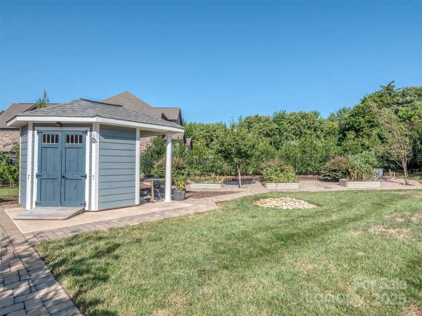 1011 Golden Bell Drive, Marvin, NC 28173.  MLS# CAR4270289, YatesRealty ID 31056. Don't miss the cutest little shed with sitting area and raised bed garden area!