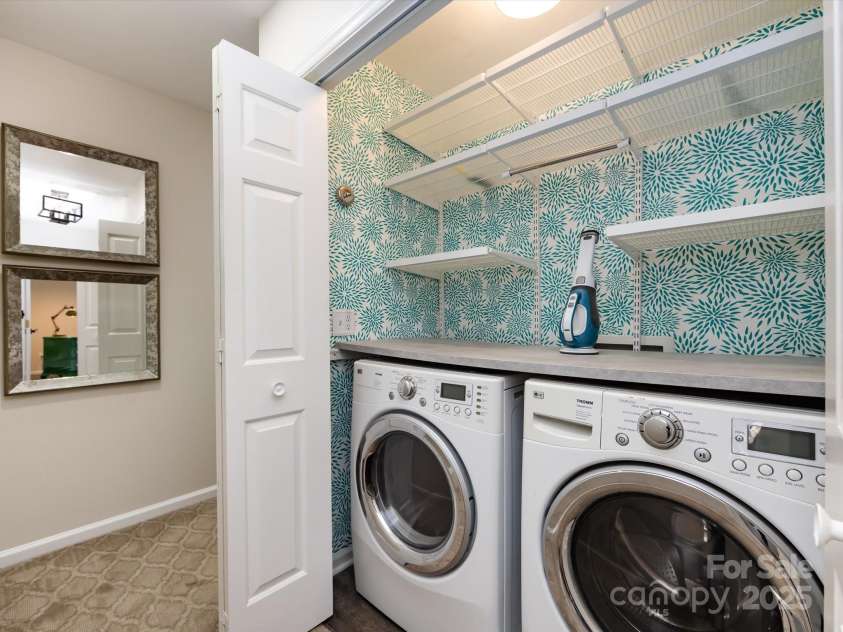 3508 Colony Crossing Drive, Charlotte, NC 28226.  MLS# CAR4279555, YatesRealty ID 31072. Laundry closet in upstairs hall features wallpaper accent wall and shelving