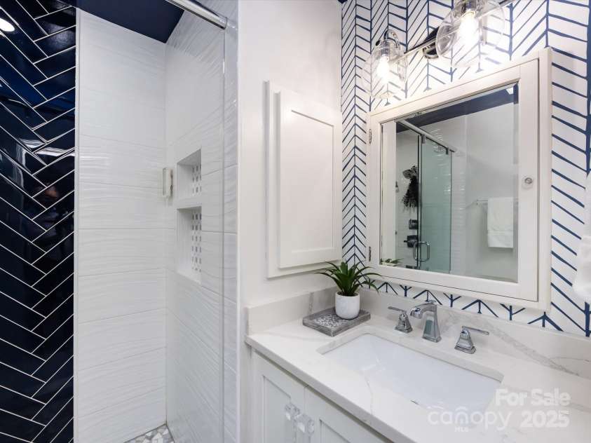 3508 Colony Crossing Drive, Charlotte, NC 28226.  MLS# CAR4279555, YatesRealty ID 31072. Renovated primary bath with designer tile, vanity and thoughtfully placed storage