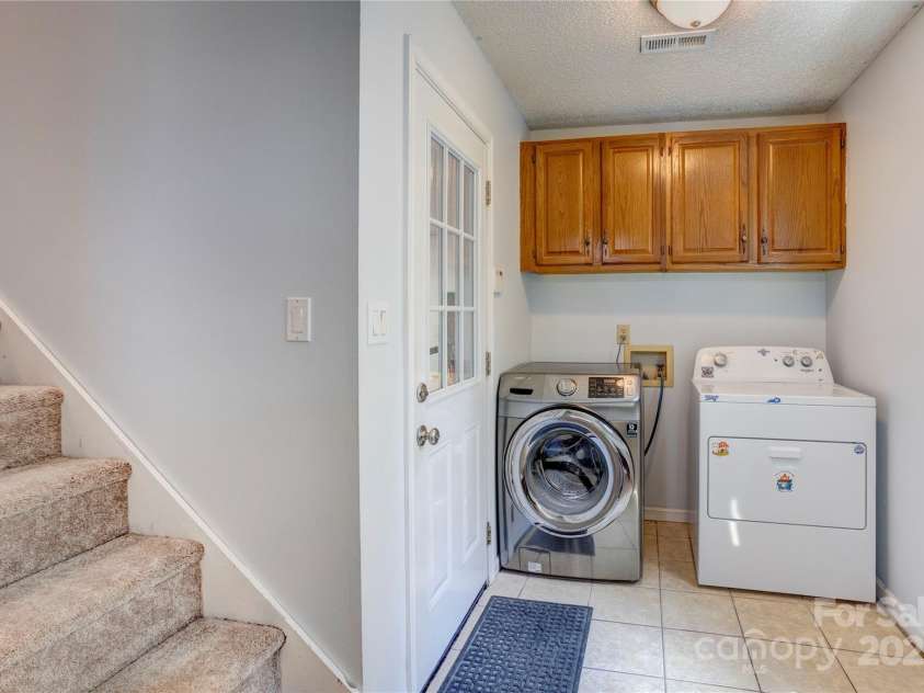 8913 Gosnell Drive, Charlotte, NC 28227.  MLS# CAR4289170, YatesRealty ID 31091. Washer and dryer will stay for buyer. Laundry room also entrance to garage and stairway to bonus room, attic storage. 