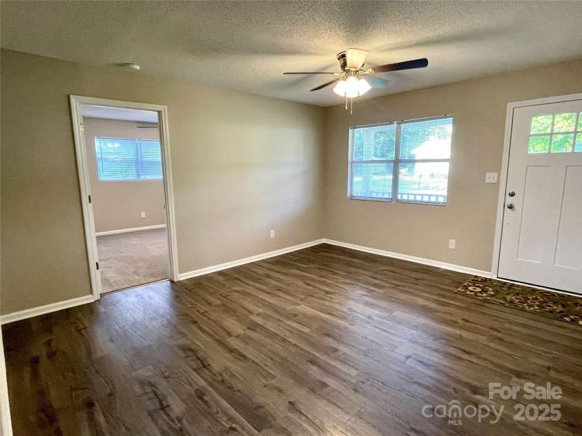 400 Lucy Avenue, Concord, NC 28027.  MLS# CAR4280783, YatesRealty ID 31101. Livingroom looking into primary bedroom