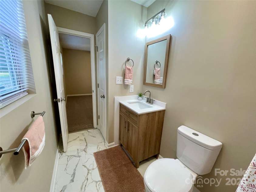 400 Lucy Avenue, Concord, NC 28027.  MLS# CAR4280783, YatesRealty ID 31101. Primary bthr w/new floor, commode, mirror & lights