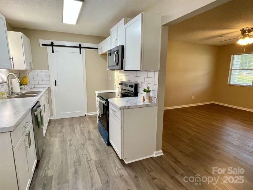 400 Lucy Avenue, Concord, NC 28027.  MLS# CAR4280783, YatesRealty ID 31101. Sliding door closing off laundry room