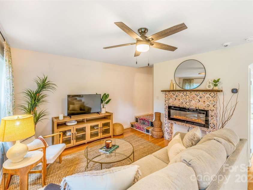 45 Heather Mist Drive, Weaverville, NC 28787.  MLS# CAR4282171, YatesRealty ID 31108. Cozy living room with feature electric fire place.