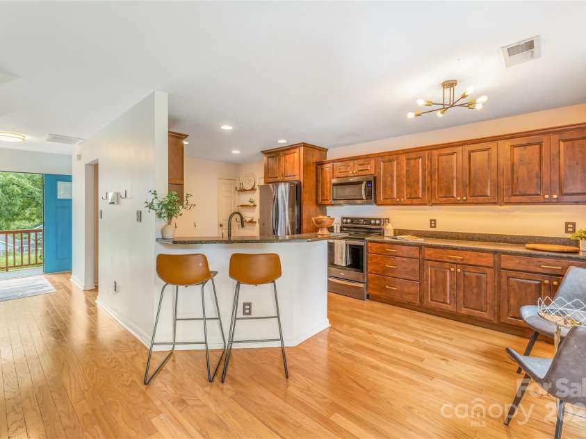 45 Heather Mist Drive, Weaverville, NC 28787.  MLS# CAR4282171, YatesRealty ID 31108. Kitchen is open to living room area