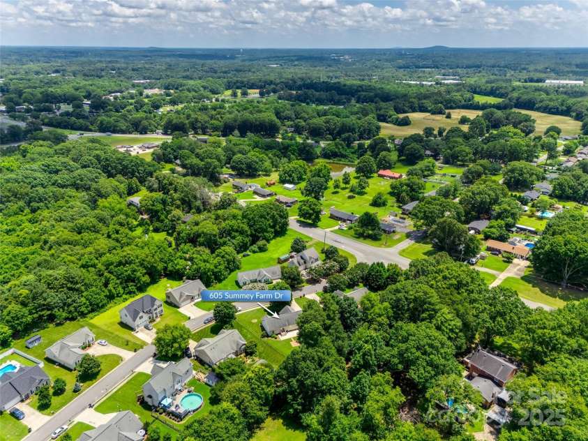 605 Summey Farm Drive, Dallas, NC 28034.  MLS# CAR4249509, YatesRealty ID 31112. Aerial View from Back of Property w/ Mountains in Distance