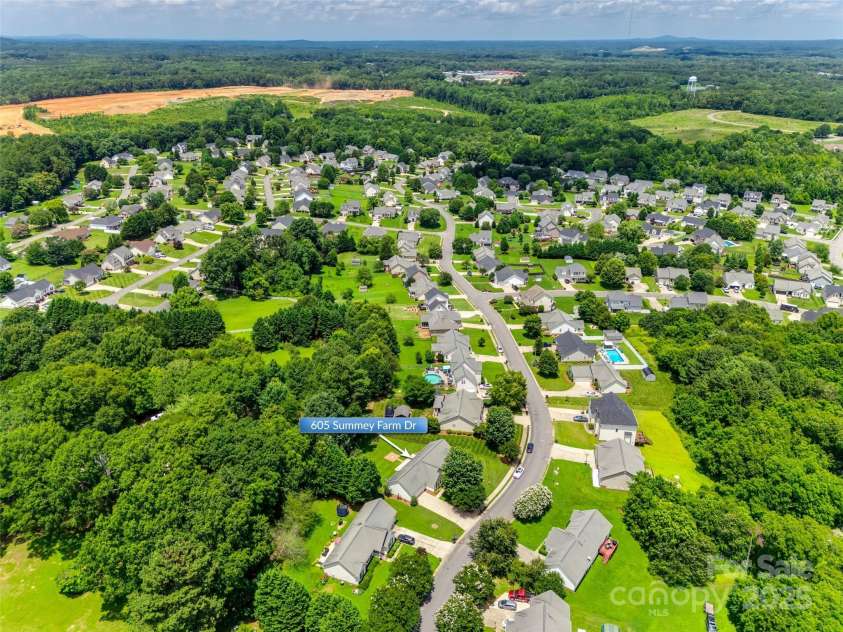 605 Summey Farm Drive, Dallas, NC 28034.  MLS# CAR4249509, YatesRealty ID 31112. Aerial View from Side of Property w/ Mountains in Distance