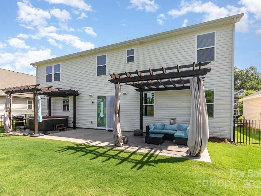 7414 Meridale Forest Drive, Charlotte, NC 28269.  MLS# CAR4264333, YatesRealty ID 31114. Expanded Back Patio with double pergolas and hot tub