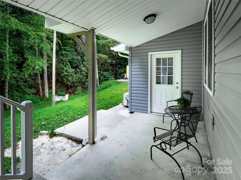 140 Bald Rock Road, Hendersonville, NC 28792.  MLS# CAR4284431, YatesRealty ID 31119. Rear porch facing the rear studio door.