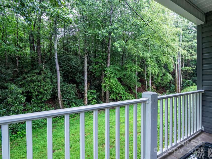 140 Bald Rock Road, Hendersonville, NC 28792.  MLS# CAR4284431, YatesRealty ID 31119. View of the back yard towards the stream