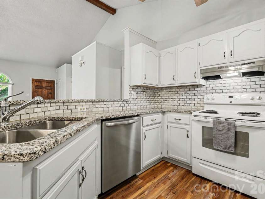 12619 Levins Hall Road, Huntersville, NC 28078.  MLS# CAR4388537, YatesRealty ID 31120. Kitchen with granite counters and tile backsplash.