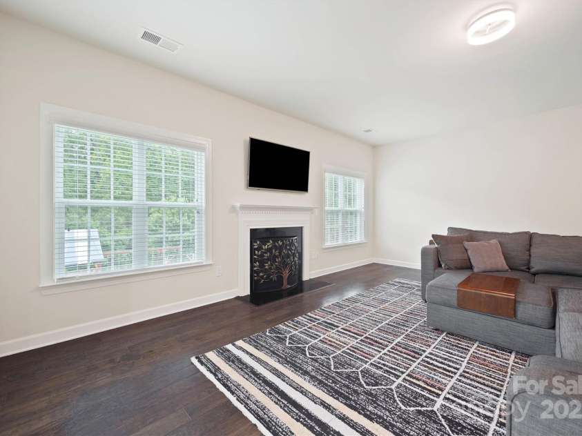 16928 Alydar Commons Lane, Charlotte, NC 28278.  MLS# CAR4289485, YatesRealty ID 31124. Great room with gas fireplace and large windows