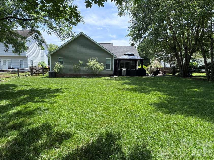 3930 Huntmeadow Drive, Charlotte, NC 28269.  MLS# CAR4387063, YatesRealty ID 31125. The backyard provide some shade from trees and you will enjoy relaxing while taking in nature