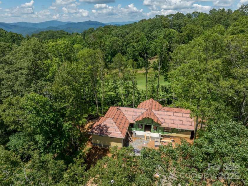 296 Austin Mountain Drive, Burnsville, NC 28714.  MLS# CAR4278654, YatesRealty ID 31142. Drone imagery of the build and location.