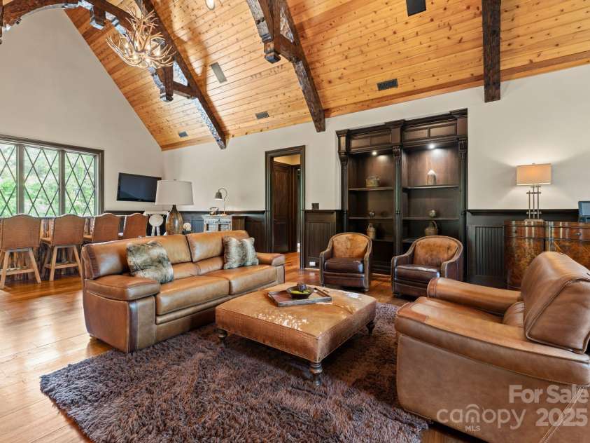 172 Tennessee Circle, Mooresville, NC 28117.  MLS# CAR4252701, YatesRealty ID 3115. Guest Apartment Living Room is an open-concept space with Samsung TV and built-in shelving.