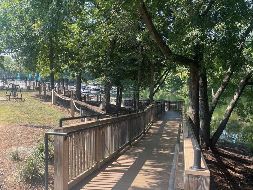 19942 Scanmar Lane, Cornelius, NC 28031.  MLS# CAR4381771, YatesRealty ID 31153. Beautiful tree lined walkway to the marina. Easily roll your cooler or wagon to your boat. 