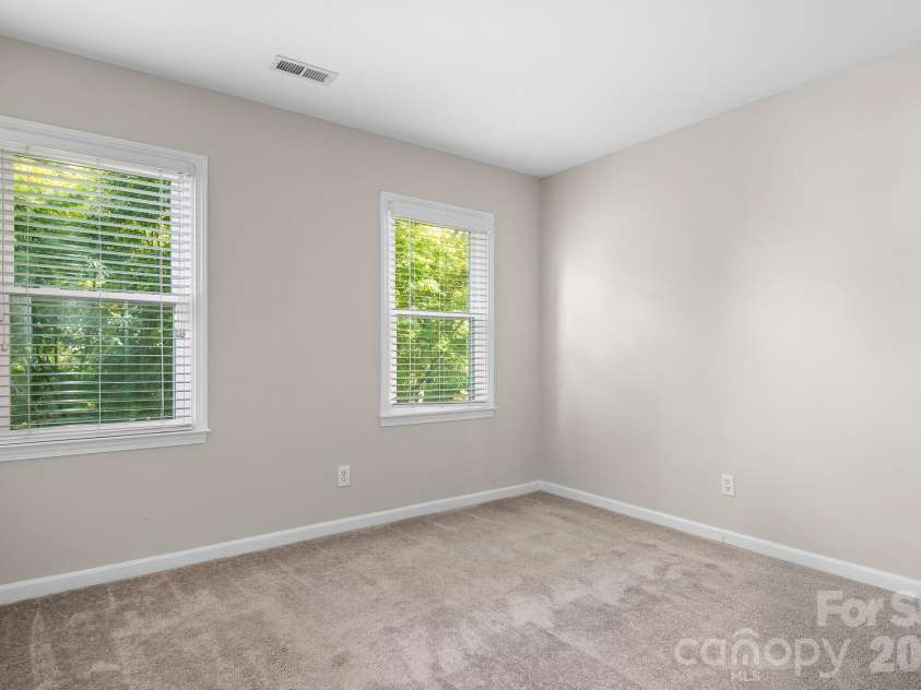 19942 Scanmar Lane, Cornelius, NC 28031.  MLS# CAR4381771, YatesRealty ID 31153. Bedroom 4. Bright windows overlooking front yard.