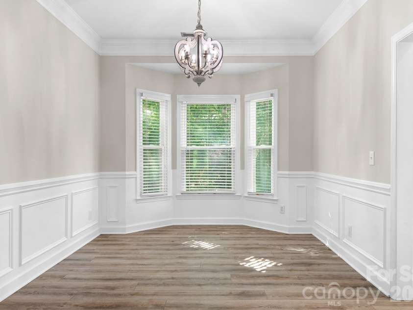 19942 Scanmar Lane, Cornelius, NC 28031.  MLS# CAR4381771, YatesRealty ID 31153. Dining Room with bay window, designer chandelier. Fresh paint and solid LVP flooring.