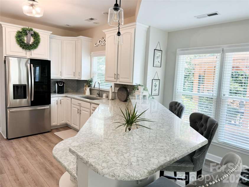 19942 Scanmar Lane, Cornelius, NC 28031.  MLS# CAR4381771, YatesRealty ID 31153. Kitchen features large breakfast bar perfect for entertaining! 