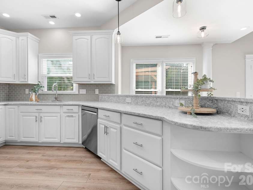 19942 Scanmar Lane, Cornelius, NC 28031.  MLS# CAR4381771, YatesRealty ID 31153. Kitchen with Quartz Counters, Large Breakfast Bar area, Tons of Cabinets, Pantry, Built in Microwave, Refrigerator and Double oven.Recessed Dimmer Lights, LVP Flooring, and Open to Family Room