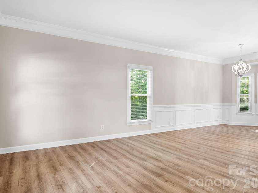19942 Scanmar Lane, Cornelius, NC 28031.  MLS# CAR4381771, YatesRealty ID 31153. Living and diningRoom. Smooth ceilings, fresh paint and solid LVP flooring throughout.