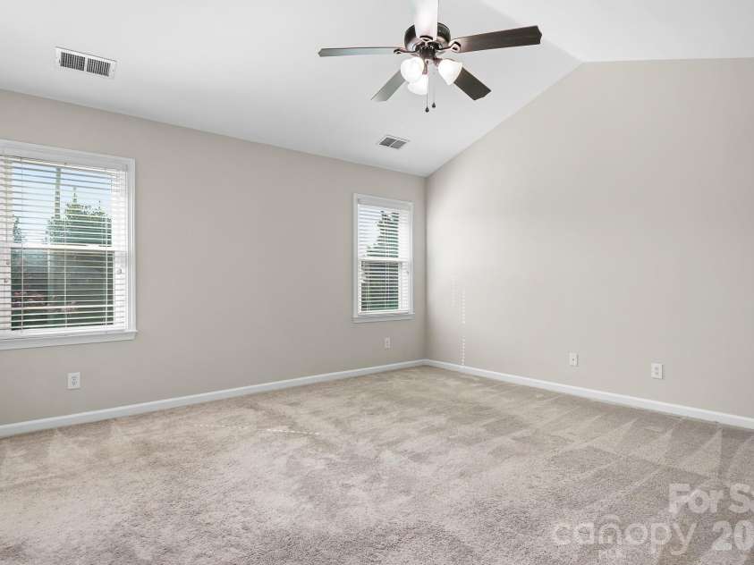 19942 Scanmar Lane, Cornelius, NC 28031.  MLS# CAR4381771, YatesRealty ID 31153. Primary Bedroom. Angled Ceilings with Ceiling Fan. Walk in Closet.