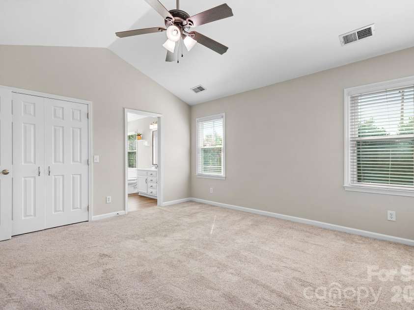 19942 Scanmar Lane, Cornelius, NC 28031.  MLS# CAR4381771, YatesRealty ID 31153. Primary Bedroom. Angled Ceilings with Ceiling Fan. Walk in Closet.