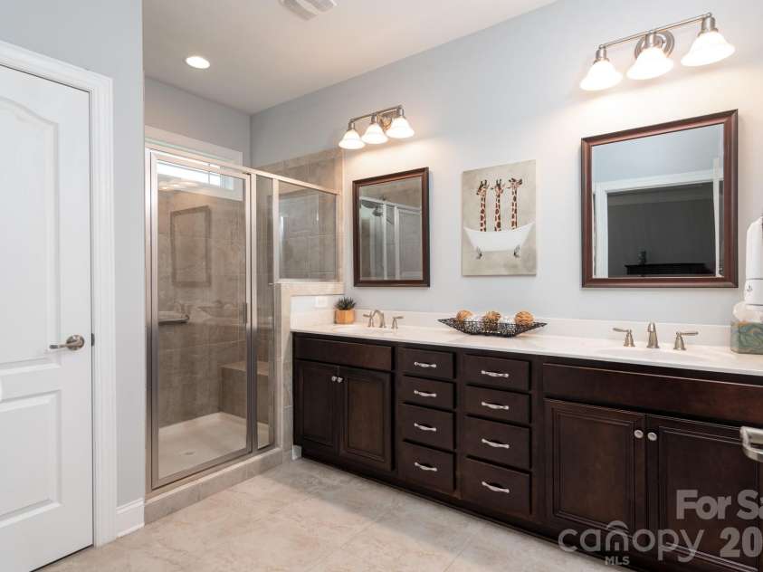 17718 Morehampton Avenue, Cornelius, NC 28031.  MLS# CAR4389501, YatesRealty ID 31154. Dual sinks, tiled shower, spacious linen in primary bath.