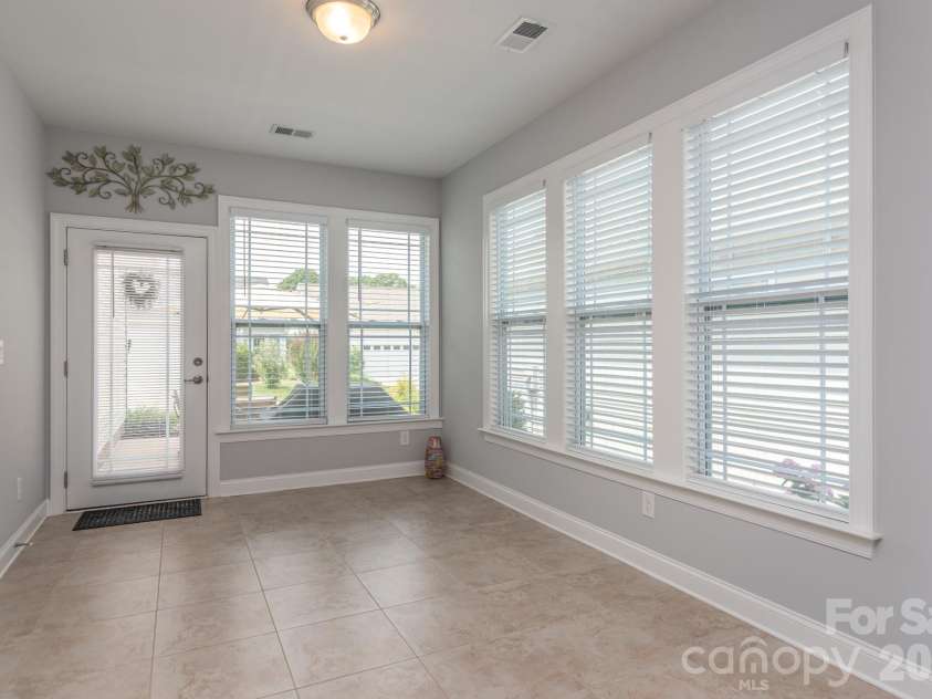 17718 Morehampton Avenue, Cornelius, NC 28031.  MLS# CAR4389501, YatesRealty ID 31154. Sunroom would also make a fabulous art studio overlooking patio!