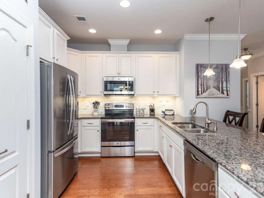 17718 Morehampton Avenue, Cornelius, NC 28031.  MLS# CAR4389501, YatesRealty ID 31154. Tiled splash, stainbless appliances,  and granite counters