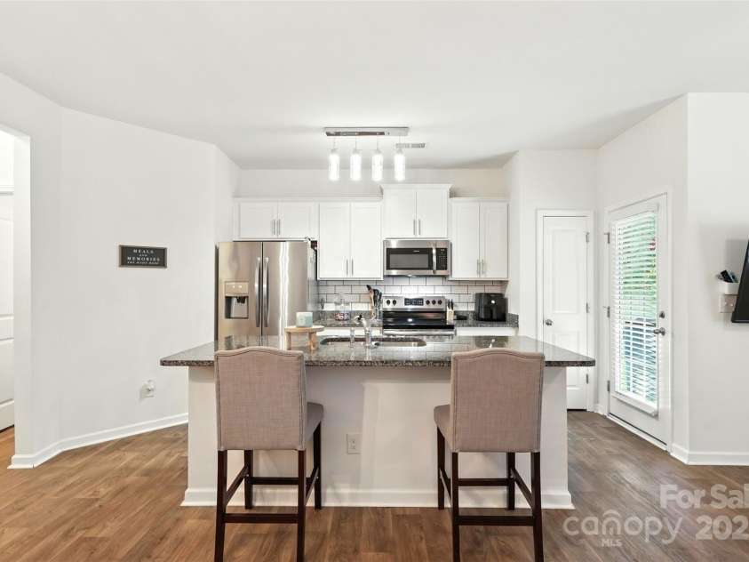 6018 Guildford Hill Lane, Charlotte, NC 28215.  MLS# CAR4287147, YatesRealty ID 31154. Alternate view of the kitchen highlighting the island as the central focal point of the space. Modern light fixtures adds a stylish touch.