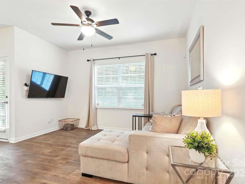 6018 Guildford Hill Lane, Charlotte, NC 28215.  MLS# CAR4287147, YatesRealty ID 31154. Living room features a large window allowing ample natural light to shine through and direct access to the patio.