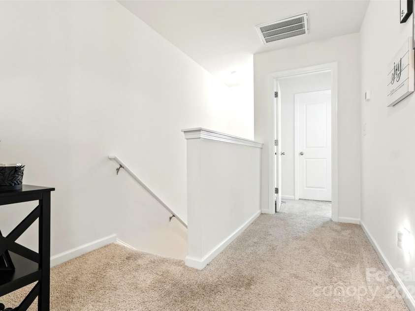 6018 Guildford Hill Lane, Charlotte, NC 28215.  MLS# CAR4287147, YatesRealty ID 31154. Open landing at the top of the stairs, ideal for a small desk, reading nook, or photo gallery wall.