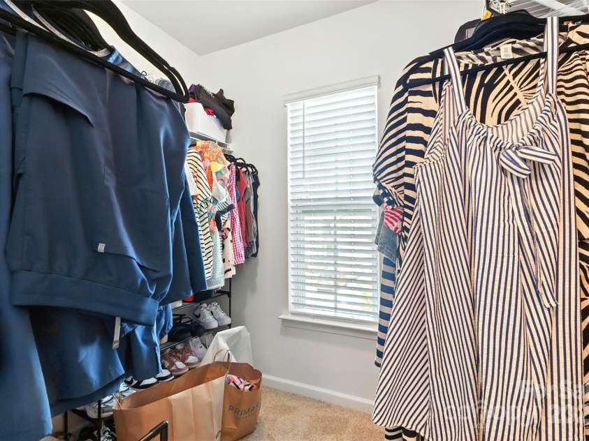6018 Guildford Hill Lane, Charlotte, NC 28215.  MLS# CAR4287147, YatesRealty ID 31154. Owner's suite walk-in closet featuring a window to provide additional natural light.