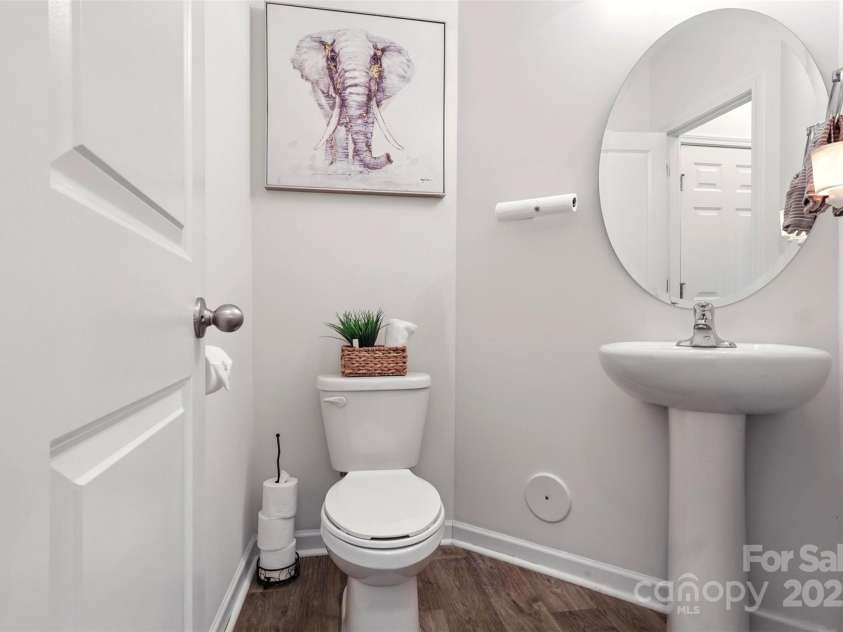 6018 Guildford Hill Lane, Charlotte, NC 28215.  MLS# CAR4287147, YatesRealty ID 31154. Powder room tucked away discreetly off the main living area.