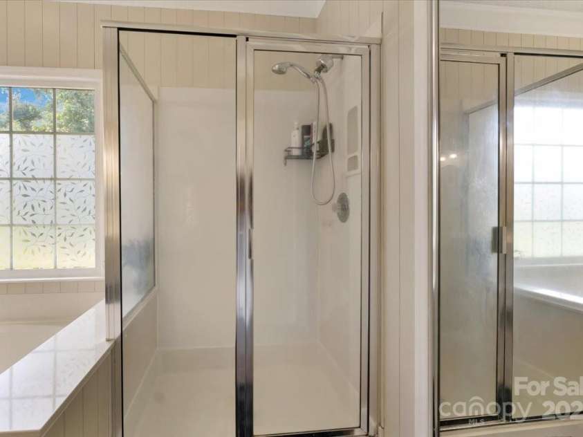 1524 Candlewyck Court, Kannapolis, NC 28081.  MLS# CAR4279653, YatesRealty ID 31163. Primary ensuite bathroom with dual sinks  tiled floors, updated lighting, separate tub and shower, and a water closet.