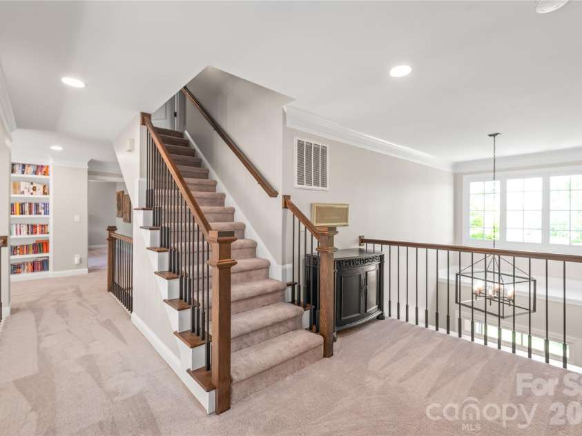 25017 Stonekirk Lane, Fort Mill, SC 29707.  MLS# CAR4383231, YatesRealty ID 31182. Heading up to the third level, the stairs feature soft, comfortable carpeting underfoot while maintaining that sleek, contemporary look with the updated modern spindles.