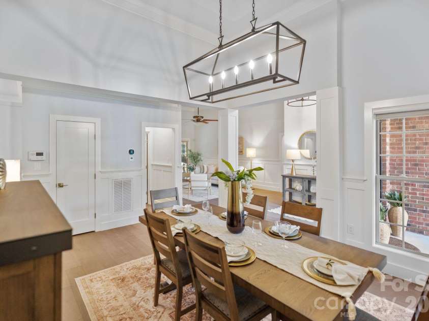 526 Ballymote Court, Matthews, NC 28104.  MLS# CAR4388258, YatesRealty ID 31207. Dining Room – Bright and inviting dining area highlighted by custom trim work, soaring ceilings, and views of the welcoming front entry. Its central location offers convenient access to the kitchen while maintaining a d