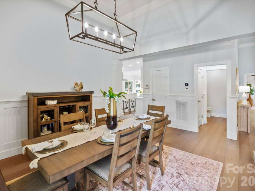 526 Ballymote Court, Matthews, NC 28104.  MLS# CAR4388258, YatesRealty ID 31207. Dining Room – Bright and inviting dining area highlighted by custom trim work, soaring ceilings, and views of the welcoming front entry. Its central location offers convenient access to the kitchen while maintaining a d