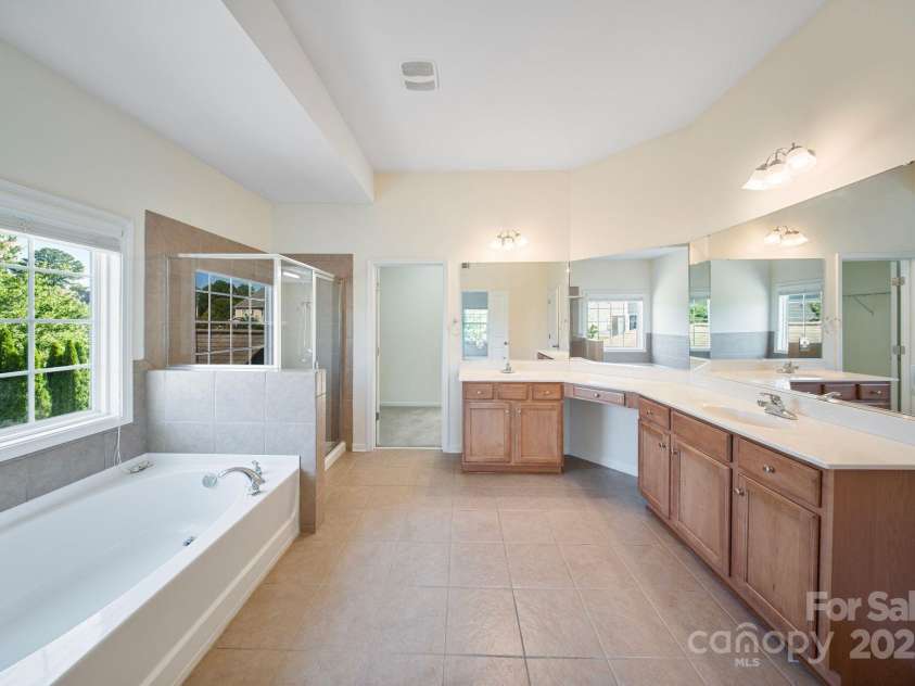 16010 Loch Raven Road, Huntersville, NC 28078.  MLS# CAR4277329, YatesRealty ID 31214. Spacious primary bath offers, dual sinks and separate tub and shower