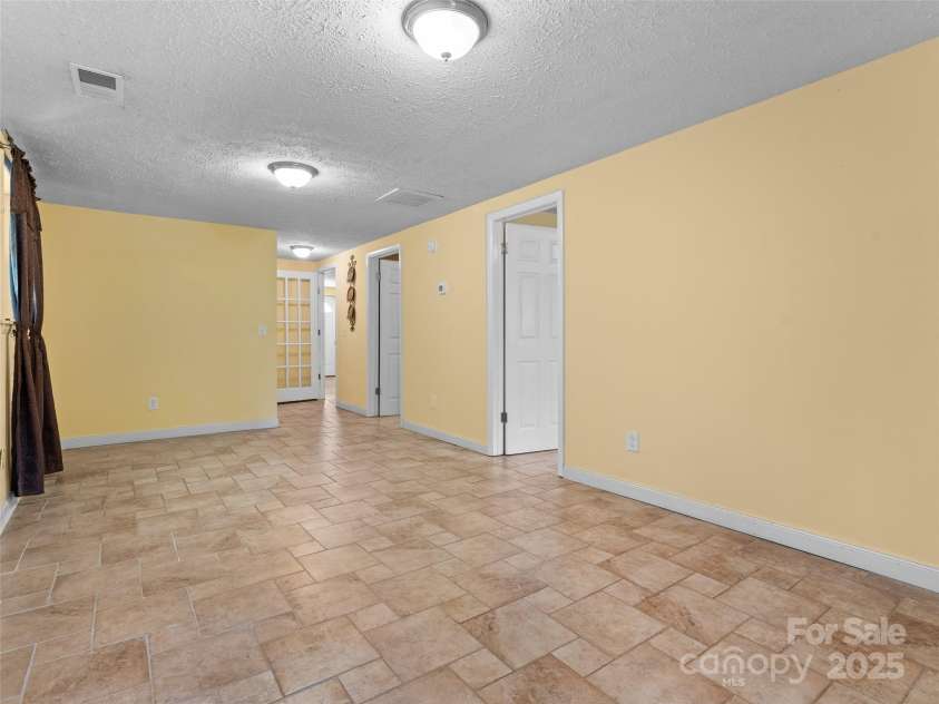 5 Granite Drive, Hendersonville, NC 28792.  MLS# CAR4266478, YatesRealty ID 31249. Great room downstairs.