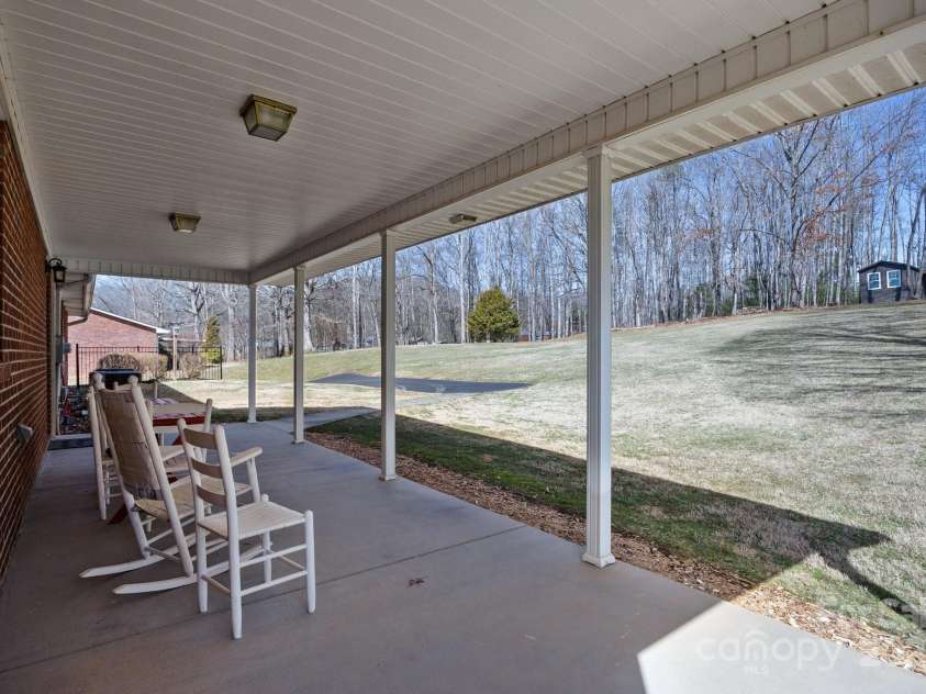 100 Young Drive, Candler, NC 28715.  MLS# CAR4230745, YatesRealty ID 3125. Back porch chilling