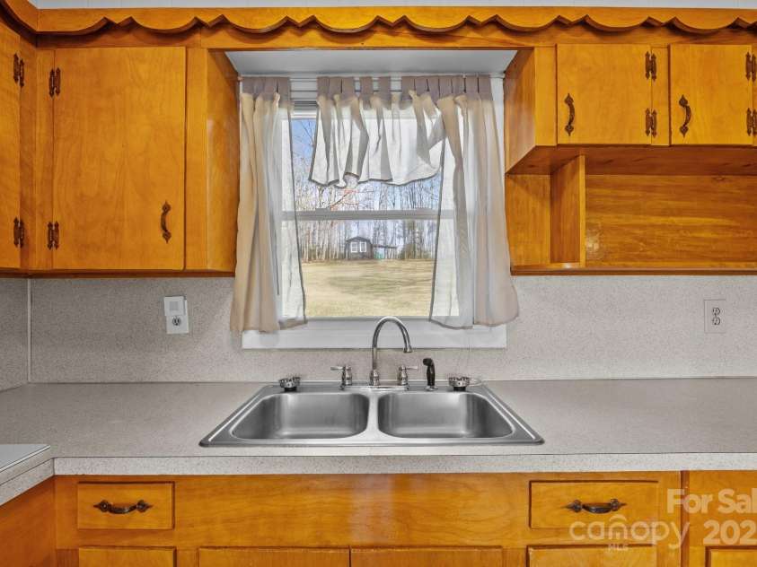 100 Young Drive, Candler, NC 28715.  MLS# CAR4230745, YatesRealty ID 3125. Back yard from the kitchen sink
