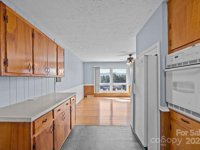 100 Young Drive, Candler, NC 28715.  MLS# CAR4230745, YatesRealty ID 3125. Kitchen into the dining room